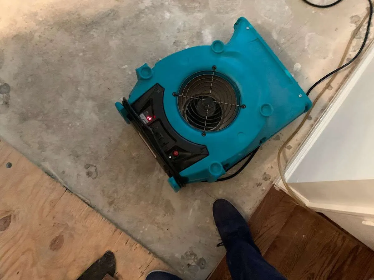 Air mover drying subfloor during Leak Detection & Repair in Mack